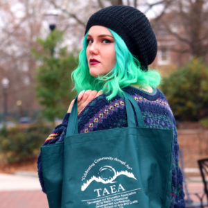 TAEA Logo and Merchandise with Model